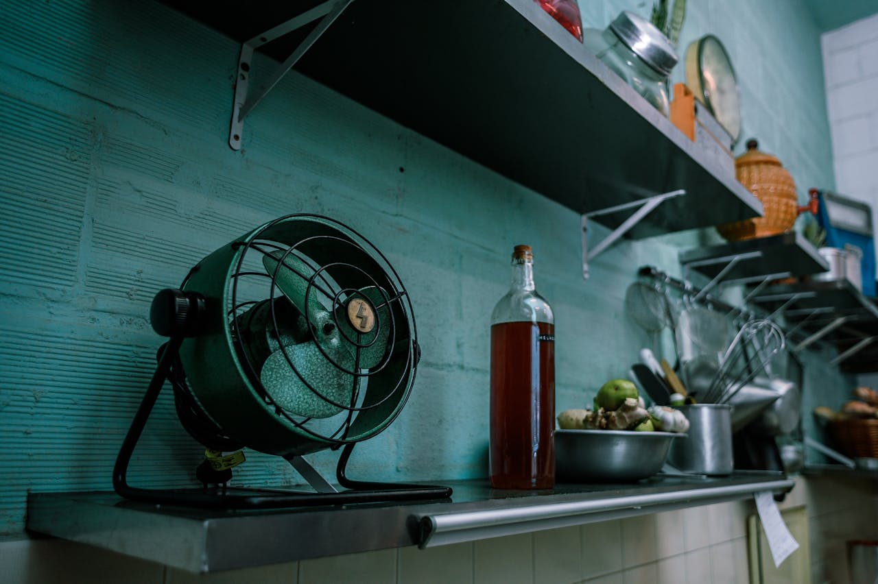 A rustic kitchen scene featuring a vintage fan, cookware, and open shelves, evoking a retro Brazilian style.